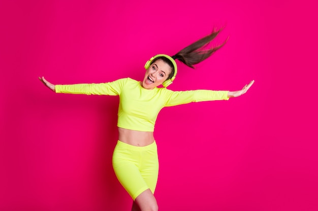 Portrait of her she nice attractive carefree cheerful cheery girl listening pop rock music enjoying dancing having fun fooling isolated bright vivid shine vibrant pink fuchsia color background