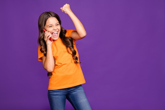 Portrait of her she nice attractive charming lovely cheerful glad satisfied wavy-haired girl talking on phone celebrating isolated on bright vivid shine vibrant lilac purple violet color background