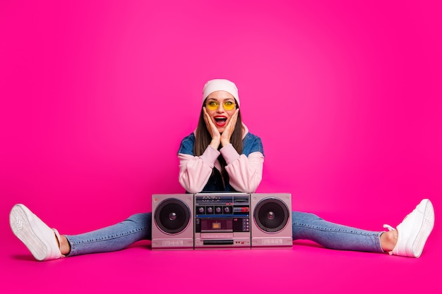 Portrait of her she nice attractive cheerful cheery overjoyed girl sitting with boom-box showing wow emotion expression isolated on bright vivid shine vibrant pink fuchsia color