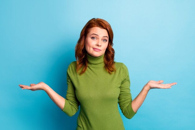 Portrait of her she nice attractive ignorant unsure wavy-haired girl shrugging shoulders don't know isolated over bright vivid shine vibrant blue turquoise teal color wall