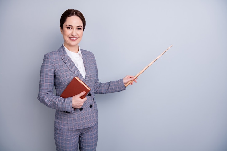 Photo portrait of her she nice attractive intellectual qualified specialist cheerful tutor using pointer showing copy space academic knowledge isolated over grey pastel color background