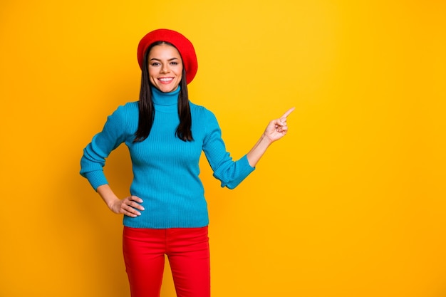Portrait of her she nice attractive lovely cheerful cheery girl pointing forefinger aside ad advert decision solution isolated over bright vivid shine vibrant yellow color wall