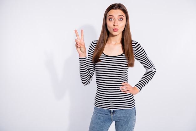 Portrait of her she nice attractive winsome shine charming cute lovely pretty cheerful cheery girlish straight-haired girl showing v-sign sending kiss isolated over white light wall