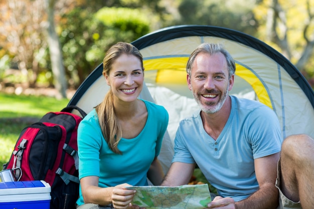 Portrait of hiker couple holding map