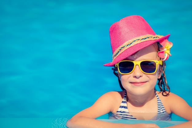 Portrait of hipster child in swimming pool. 