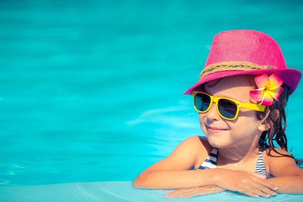 Portrait of hipster child in swimming pool. 