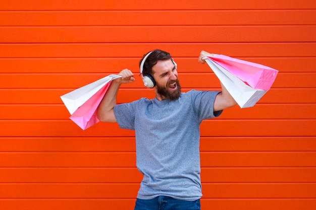 Portrait hipster guy enjoying big sales during shopping