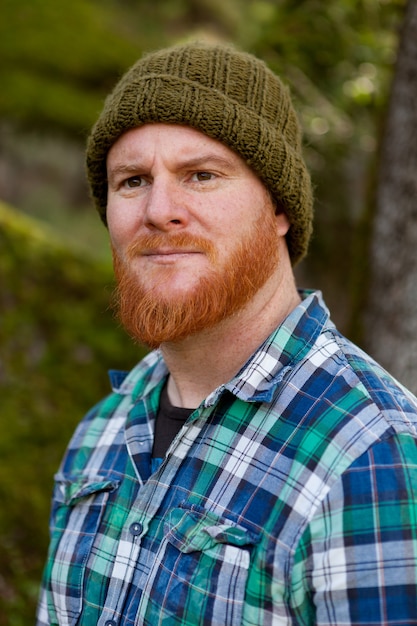 Portrait of a hipster guy thinking in the forest