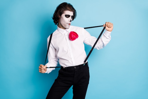 Portrait of his he handsome cool creepy diabolic elegant gentleman guy having fun pulling suspenders dancing theme occasion isolated bright vivid shine vibrant blue color background