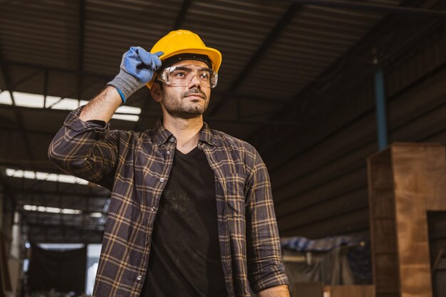 Portrait hispanic indian male wood worker standing looking happy smile construction builder man