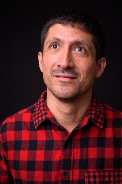 Portrait of Hispanic man against black background