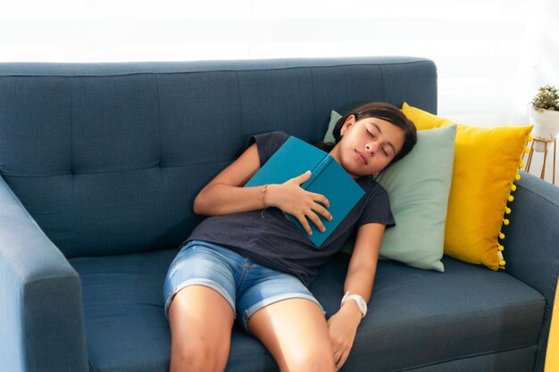 Portrait of Hispanic student sleeping after read a book.