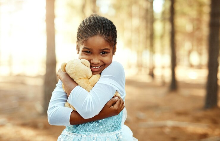 Photo portrait hug or girl with teddy bear in forest for love orphan or toy for support therapy healing or play african child nature or stuffed animal with happiness kid and donation gift for game
