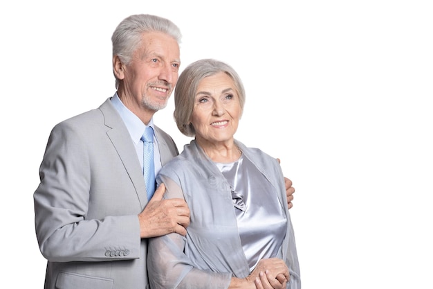 Portrait of hugging senior couple isolated on white background