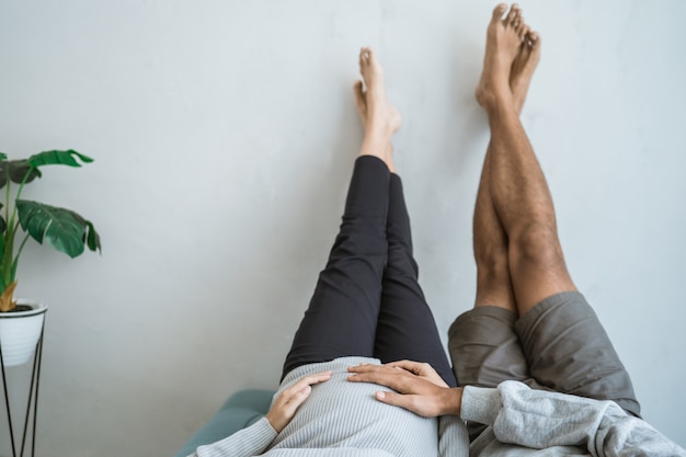 Portrait of husband and wife who are relaxing on the couch