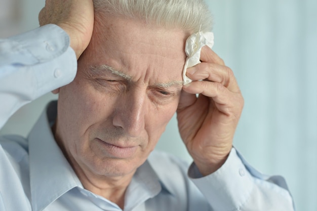 Portrait of a ill senior man suffering from pain