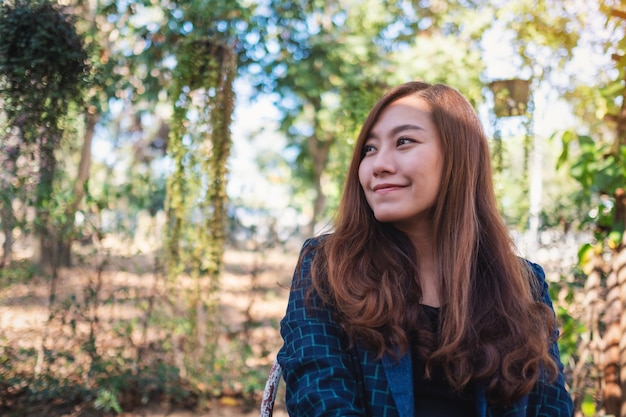 Portrait image of a beautiful asian woman sitting in the outdoors