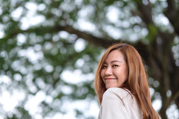 Portrait image of a beautiful young asian woman in the park