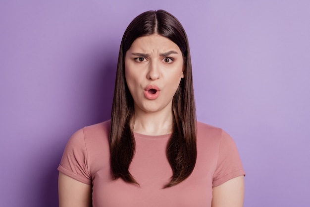 Portrait of impressed angry mad amazed shocked brunette girl open mouth isolated on violet background