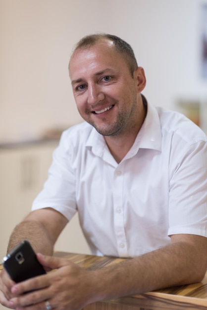 Portrait of an independent designer in his furniture manufacturing workshop, looking relaxed and confident