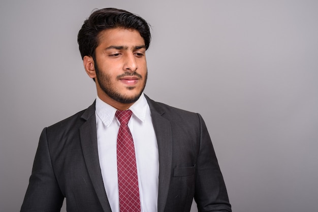 Portrait of Indian businessman against gray background