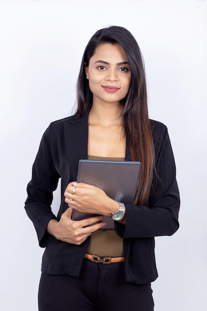 Portrait of an Indian businesswoman on white background - holding a laptop