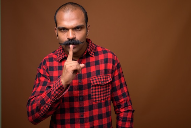 Portrait of Indian hipster man with mustache