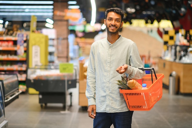 portrait of indian male in grocery with positive attitude