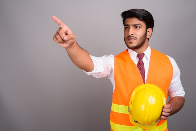 Portrait of Indian man construction worker businessman pointing finger