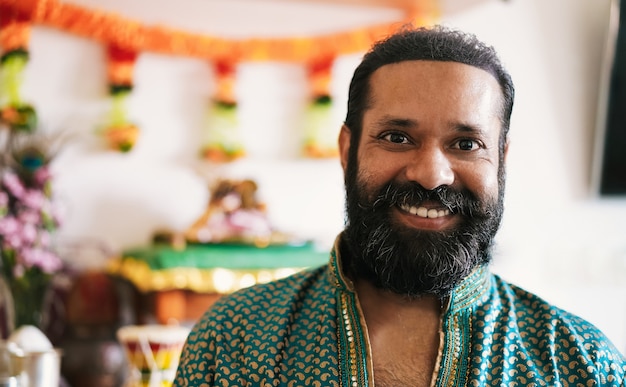 Photo portrait of indian man during religion fest at home - hindu cultures and ethnic concept - focus on face