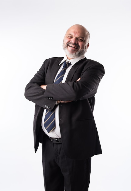 Portrait of an Indian senior businessman with arms crossed or folded. Asian matured executive in suit looking at the camera against white background