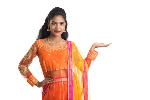 Portrait of Indian traditional woman presenting something on hand