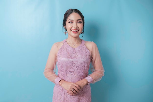 Portrait of a Indonesian woman wearing modern Kebaya standing and smiling at camera