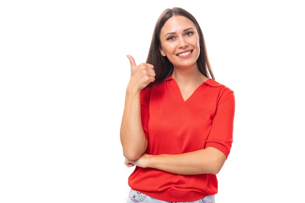 Portrait of an inspired brunette woman with straight hair in a red tshirt and jeans with an idea