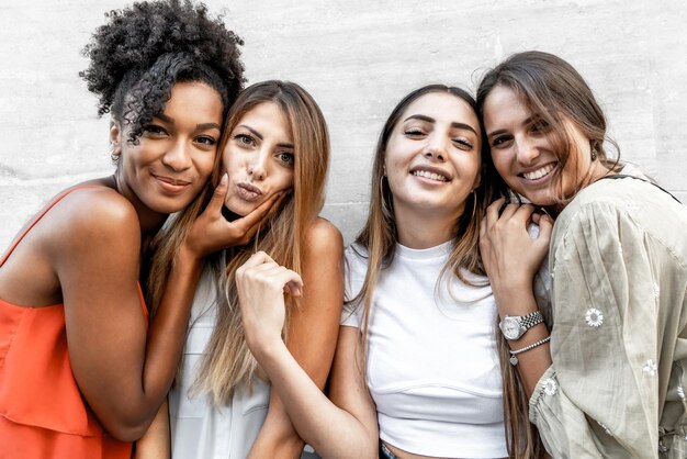 Portrait of interracial gen z girls smiling and joking watching the camera concept and friendship
