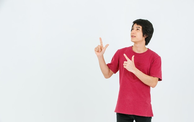 Portrait isolated cutout studio shot Asian young handsome male model in street style outfit stand posing hold hand pointing finger on copy space presenting product look at camera on white background