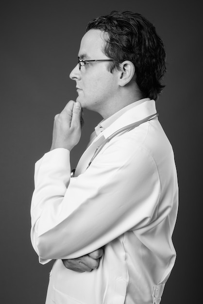 Portrait of Italian man doctor on gray in black and white