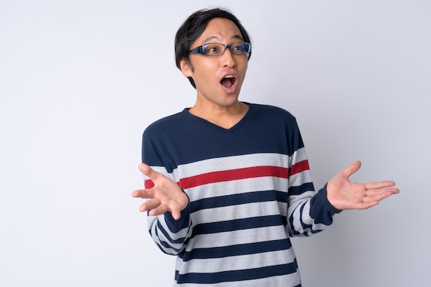 Portrait of Japanese man looking shocked with arms raised