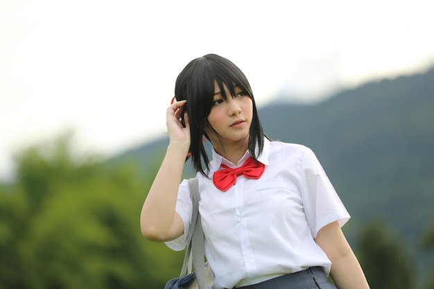 Portrait of japanese school girl outdoor in countryside