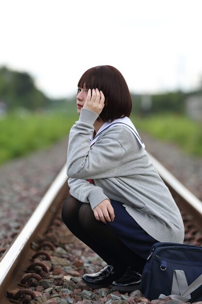 Portrait of Japanese school girl with countryside park