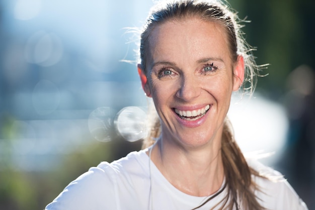 portrait of jogging woman before running  on early morning with sunrise in background