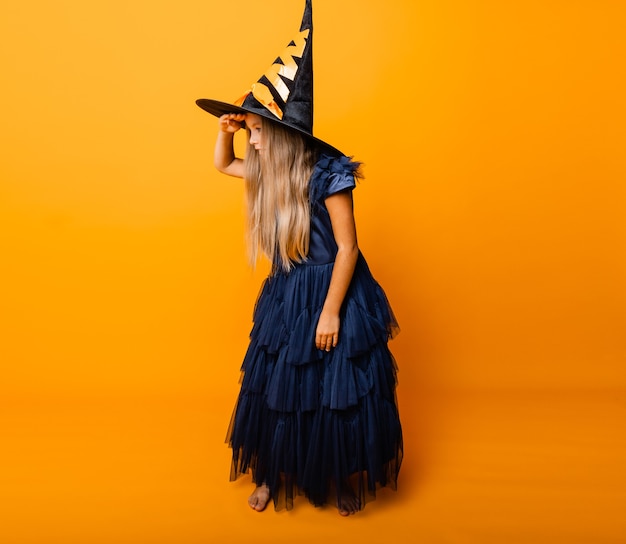 Portrait of a joyful blonde in a witch costume posing for the camera. halloween