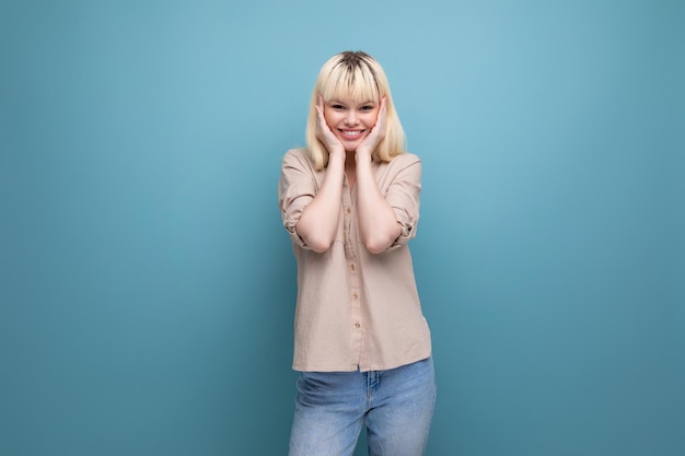 Portrait of joyful charismatic successful blonde young lady on background with copyspace