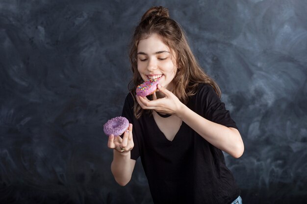 Portrait of joyful girl with donuts