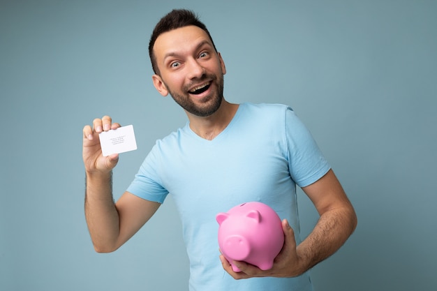 Portrait of joyful positive smiling young handsome brunet unshaven man with beard with sincere