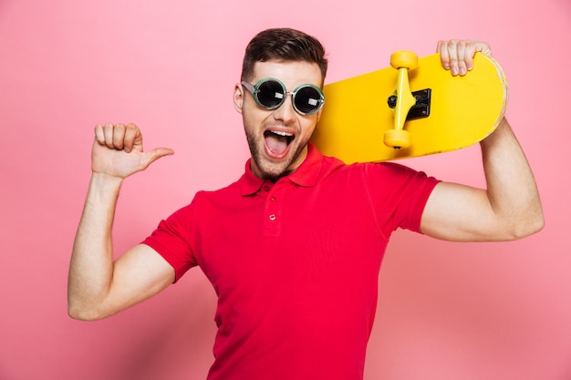 Portrait of a joyful young man in sunglasses