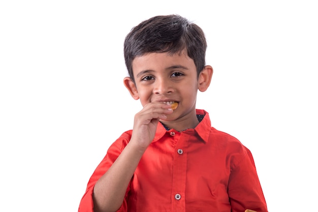 Portrait of kid eating a biscuit on white