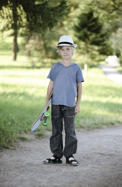 Portrait kid with skateboard outdoors