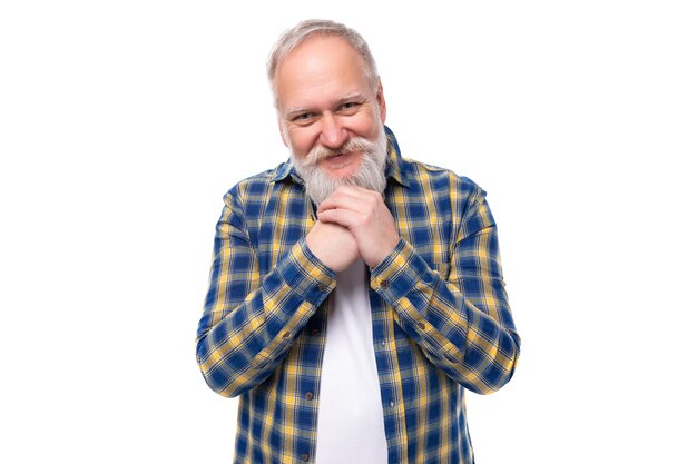 Portrait of a kind retired handsome s middleaged grayhaired man with a beard in a shirt on a white