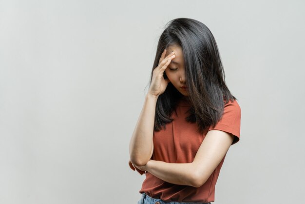 Portrait of a korean woman on a gray background Asian girl in depression